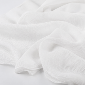 White crinkle chiffon fabric in softly rippled studio folds