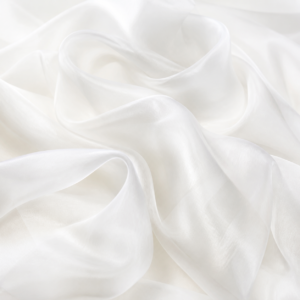 White katan organza fabric in softly layered studio folds