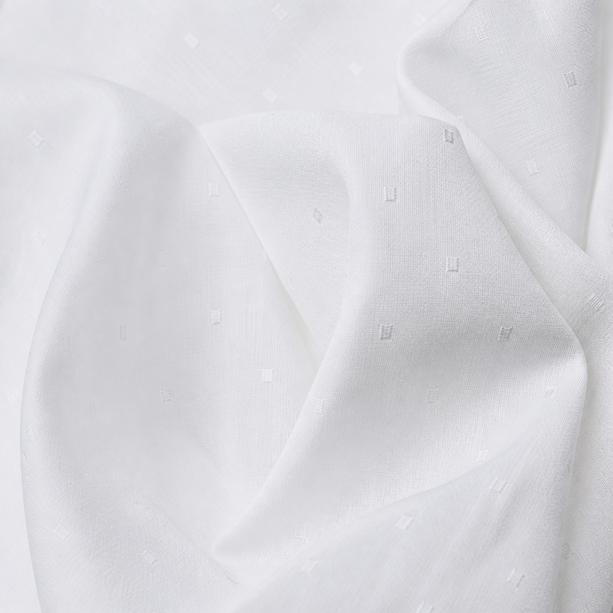 Saad Salman | Silk Fabric Manufacturer & Wholesaler White self-pattern fabric with subtle tonal dots in studio folds